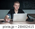 student is preparing for a lecture in classroom 28402415