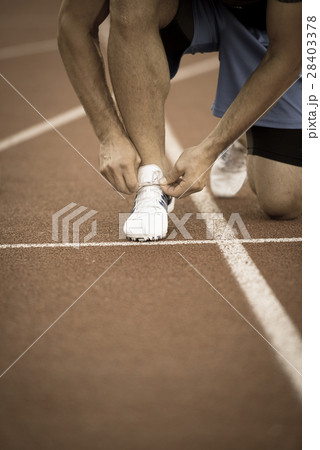 Male athlete tying laces for jogging. Man jogging 28403378