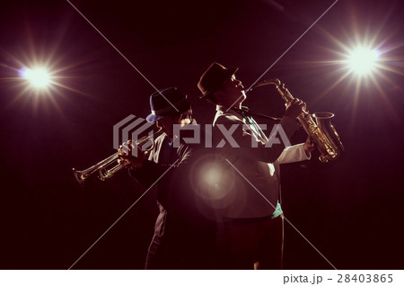 Musician Duo band playing the Trumpet with spot light and lens flare on the stage, musical concept 28403865