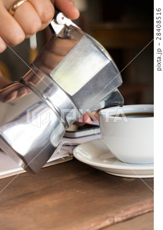 Hand on traditional italian moka pot 28408516