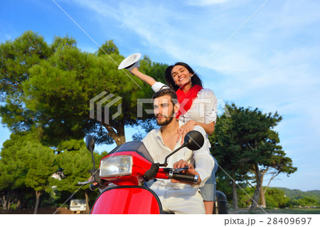 Happy couple on a scooter at summer vacation 28409697