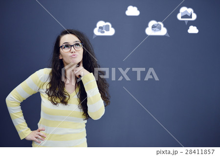 Young thinkful woman on blue gray background with 28411857