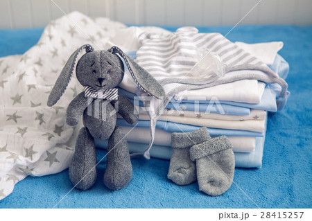 baby clothes with diapers are stacked 28415257