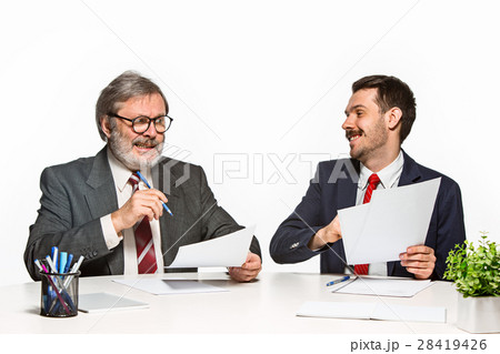 The two colleagues working together at office on 28419426