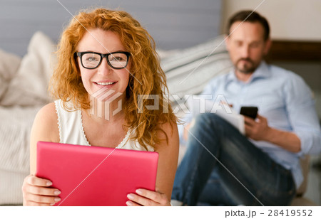 Cheerful woman sitting and smiling at home 28419552