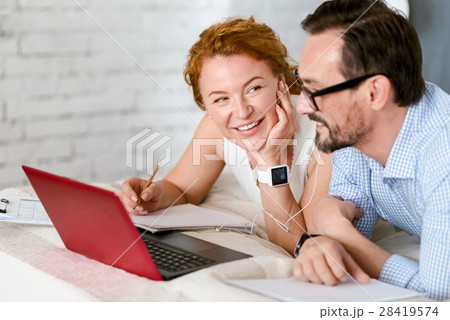 Optimistic middle aged couple expressing Optimistic middle aged couple expressing 28419574