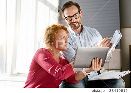 Charismatic middle aged couple sharing ideas at Charismatic middle aged couple sharing ideas at 28419615