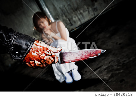 Murderer hand holding knife smeared with blood 28420218