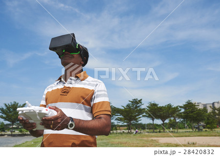 Smiling man with drone remote controller Smiling man with drone remote controller 28420832