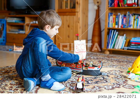 Little blond preschool kid boy playing with toy 28422071