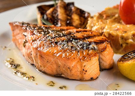 Teriyaki salmon with zucchini and lemon on white 28422566