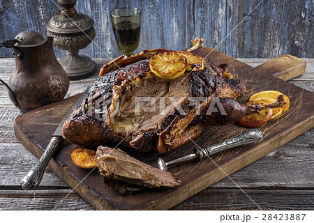 Roast Duck with Orange Slices on Cutting Board 28423887
