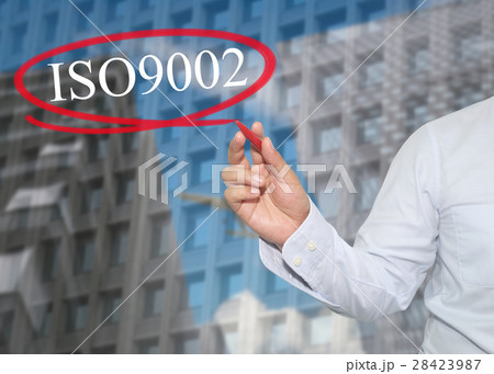 Hand of young businessman write the word ISO 9002 Hand of young businessman write the word ISO 9002 28423987