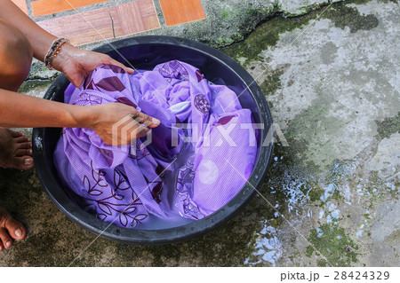Woman wash hands dirty clothes in  basin black  28424329