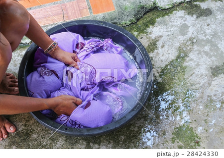Woman wash hands dirty clothes in  basin black  28424330
