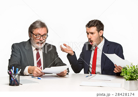 The two colleagues working together at office on The two colleagues working together at office on 28428174