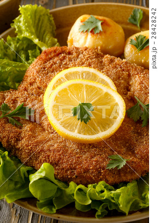Wiener schnitzel with potatoes and salad. 28428242