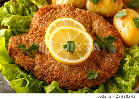 Wiener schnitzel with potatoes and salad. 28428243