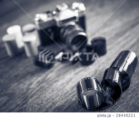 Retro photo camera on a wooden table. 28430221
