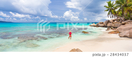 Woman enjoying Anse Patates picture perfect beach 28434037