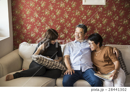 Asian family having fun in the living room together Asian family having fun in the living room together 28441302
