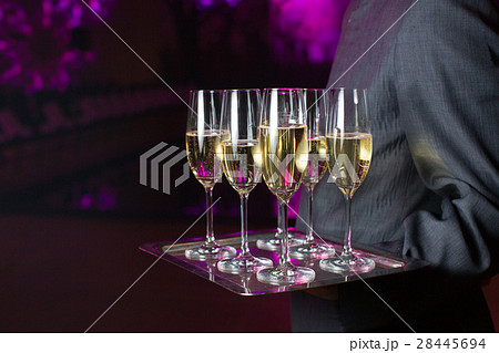 Waiter serving champagne on a tray 28445694