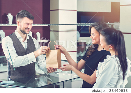 Cheerful female friends shopping jewelry at the Cheerful female friends shopping jewelry at the 28449658