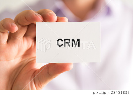 Businessman holding a card with text CRM 28451832