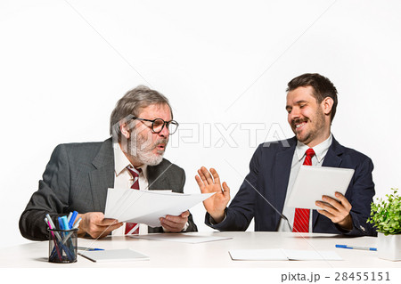 The two colleagues working together at office on The two colleagues working together at office on 28455151