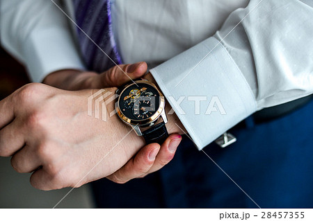 man in a tux fixing his cufflink man in a tux fixing his cufflink 28457355