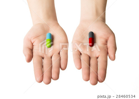 Man hands giving two big pills.  28460534