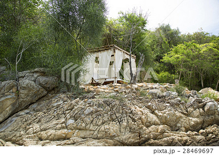 Bungalow on a rocky beach 28469697