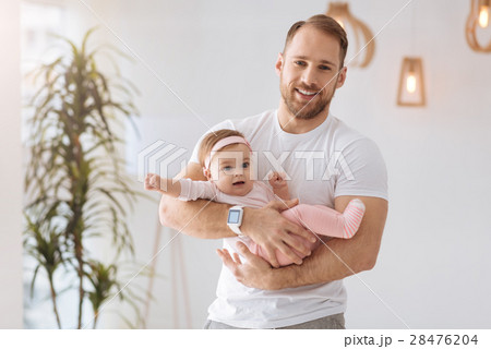 Athletic father holding the toddler in his arms at 28476204