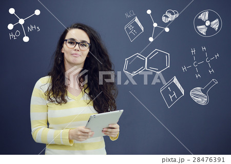 Woman with tablet in front of background with 28476391