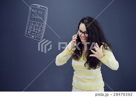 Woman talking on phone in front of background with 28476392