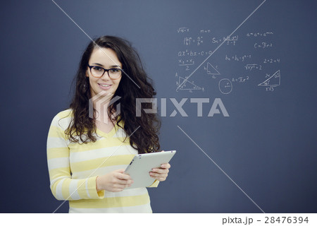 Woman with tablet in front of background with 28476394
