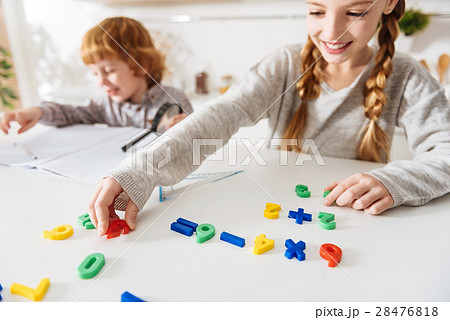 Adorable cheerful siblings doing math together 28476818