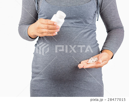 Pregnant Woman holding  pills. isolated . 28477015