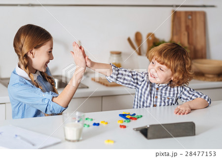 Charming brother and sister playing together Charming brother and sister playing together 28477153