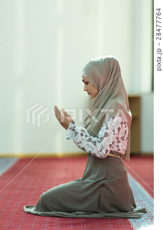 Young beautiful Muslim Woman Praying In Mosque 28477764