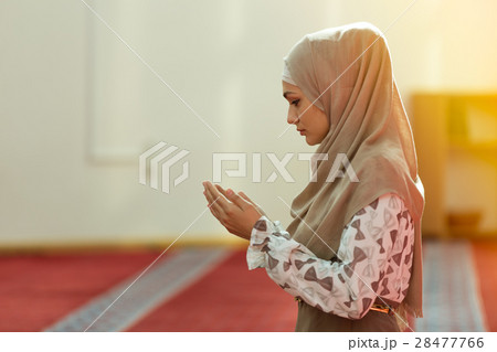 Young beautiful Muslim Woman Praying In Mosque 28477766