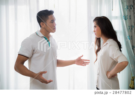 young man quarreling with his wife at home young man quarreling with his wife at home 28477802