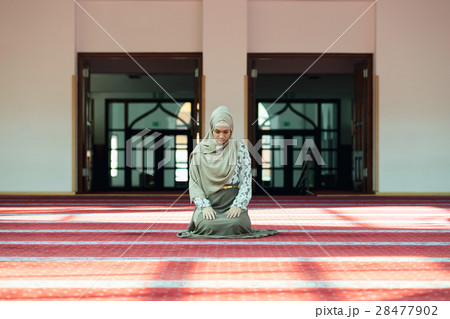 Young beautiful Muslim Woman Praying In Mosque Young beautiful Muslim Woman Praying In Mosque 28477902