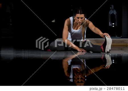 woman in a gym exercising, doing push ups. Dark 28478011