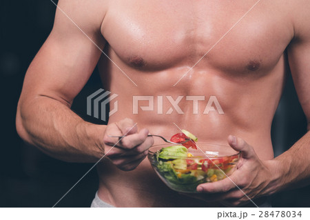 Shaped and healthy body building man holding a Shaped and healthy body building man holding a 28478034