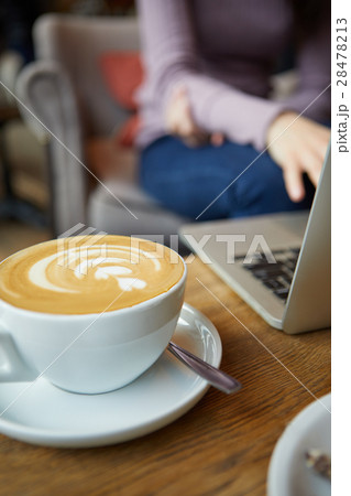 Two cups of coffee and cake on the table,latte art 28478213