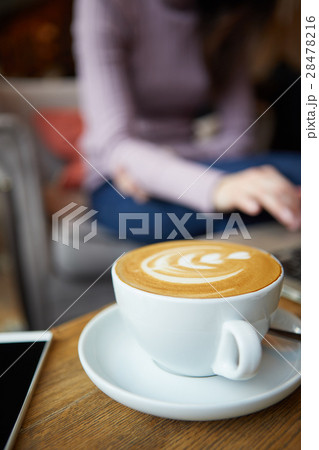 Two cups of coffee and cake on the table,latte art 28478216