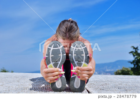 healthy young pretty woman stretching her leg 28478779