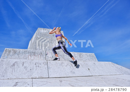 Young woman joyfully jumping in Park Young woman joyfully jumping in Park 28478790