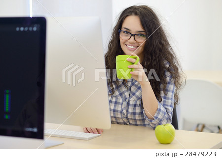 Young businesswoman on a coffee break. Using 28479223